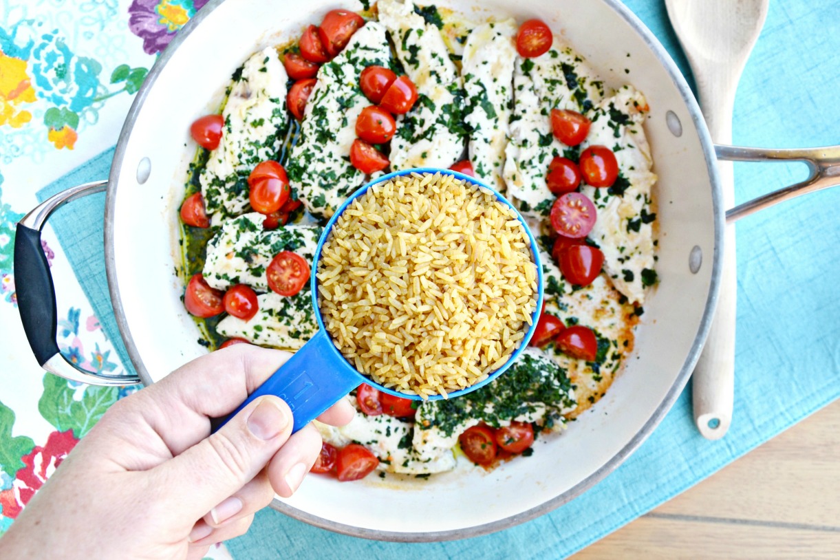 Make this easy chicken & herb summer rice skillet recipe complimented by feta cheese, lime, pineapple, tomatoes and watermelon for a quick new family favorite.