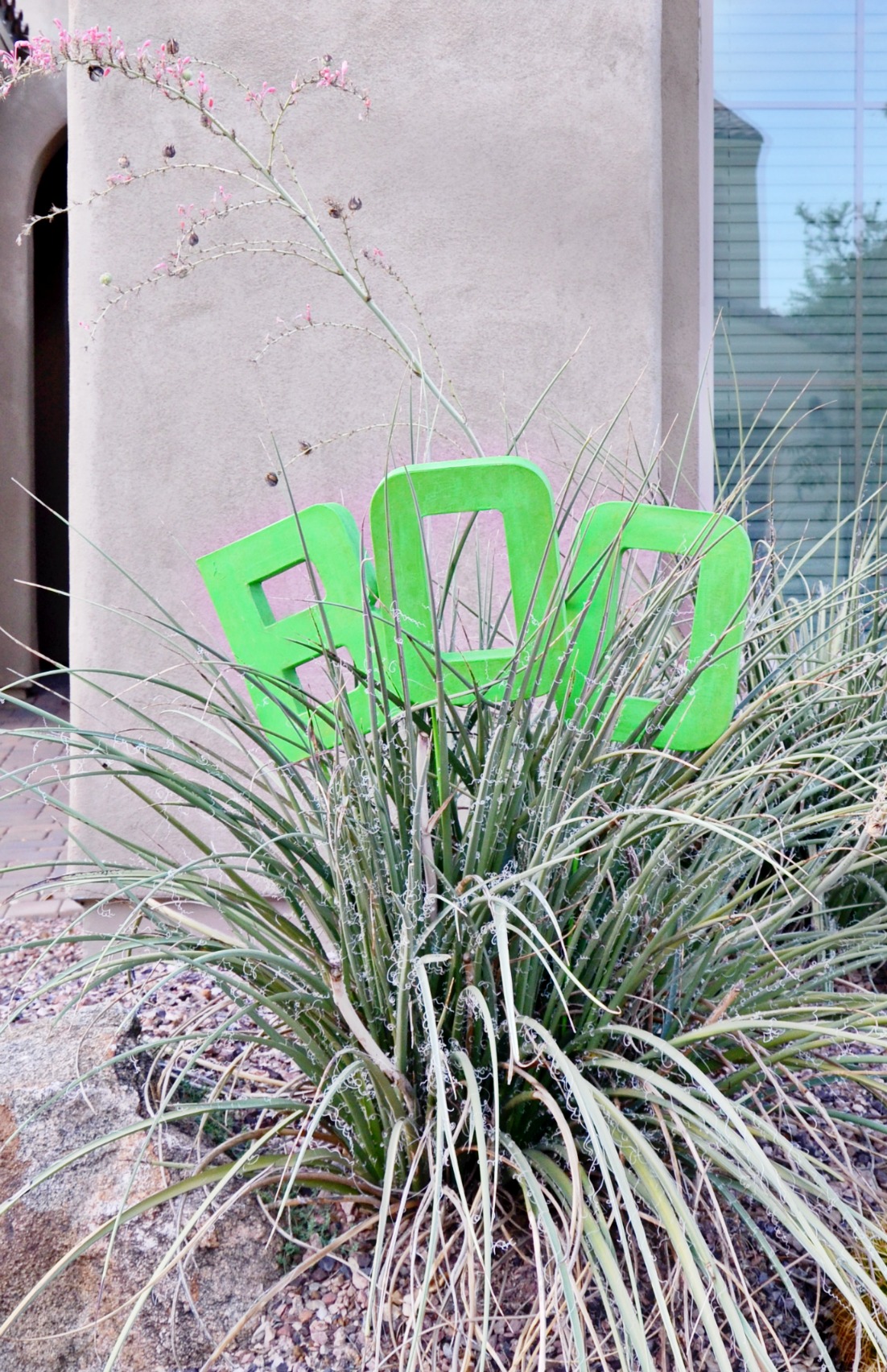 Make an easy Glow in the Dark BOO Yard Decoration with paper mache letters and glow in the dark paint to add some fun to your October yard.