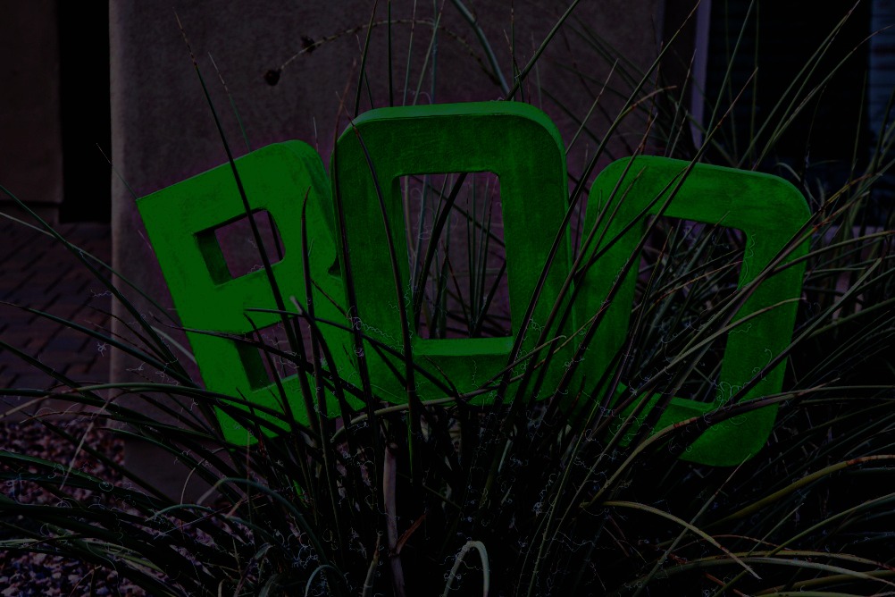 Make an easy Glow in the Dark BOO Yard Decoration with paper mache letters and glow in the dark paint to add some fun to your October yard.