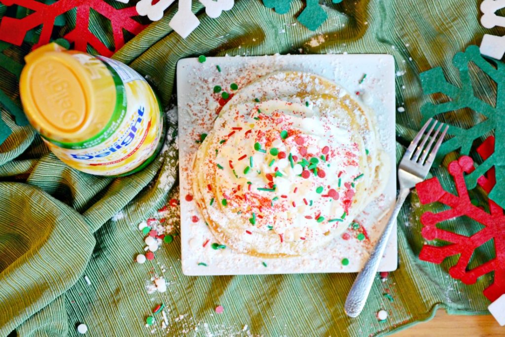 This frosted sugar cookie pancakes recipe might be the reason you show up to a holiday cookie exchange with a plate of pancakes!