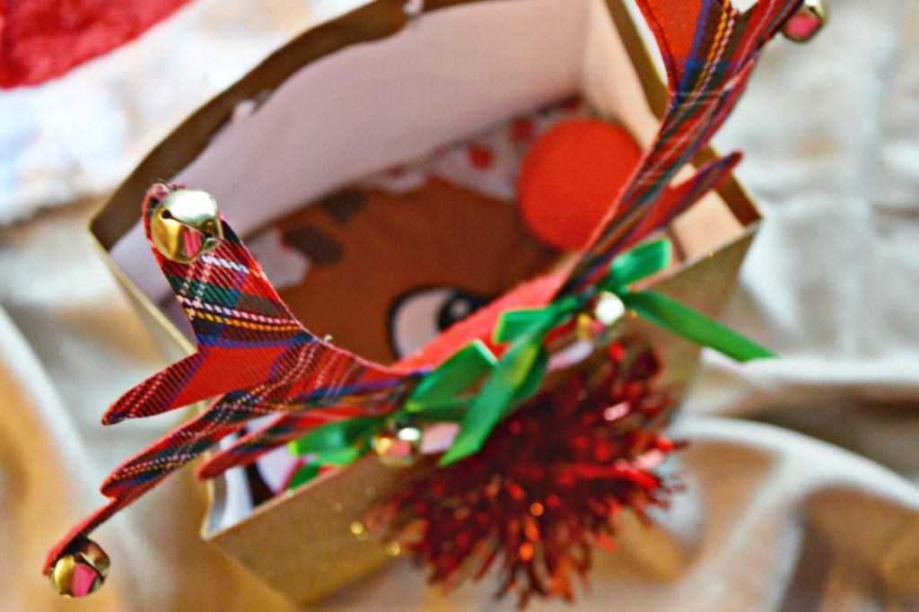 Make an easy reindeer gift bag for your family Rudolph pajamas delivery. Put pajamas in the bag, leave on your doorstep and let your children find the gift.