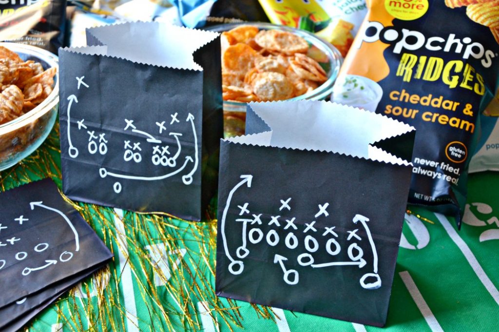 Step up your homegating snack ideas with these easy Big Game Snack Bags made with black lunch bags and a chalk marker to serve your favorite snacks.