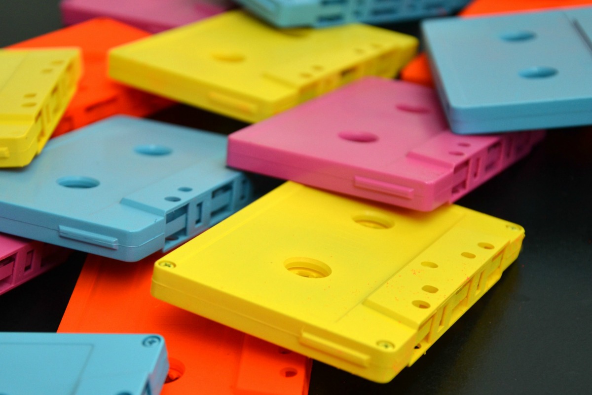 Quickly spray paint cassette tapes with neon paint for a fun party decoration.