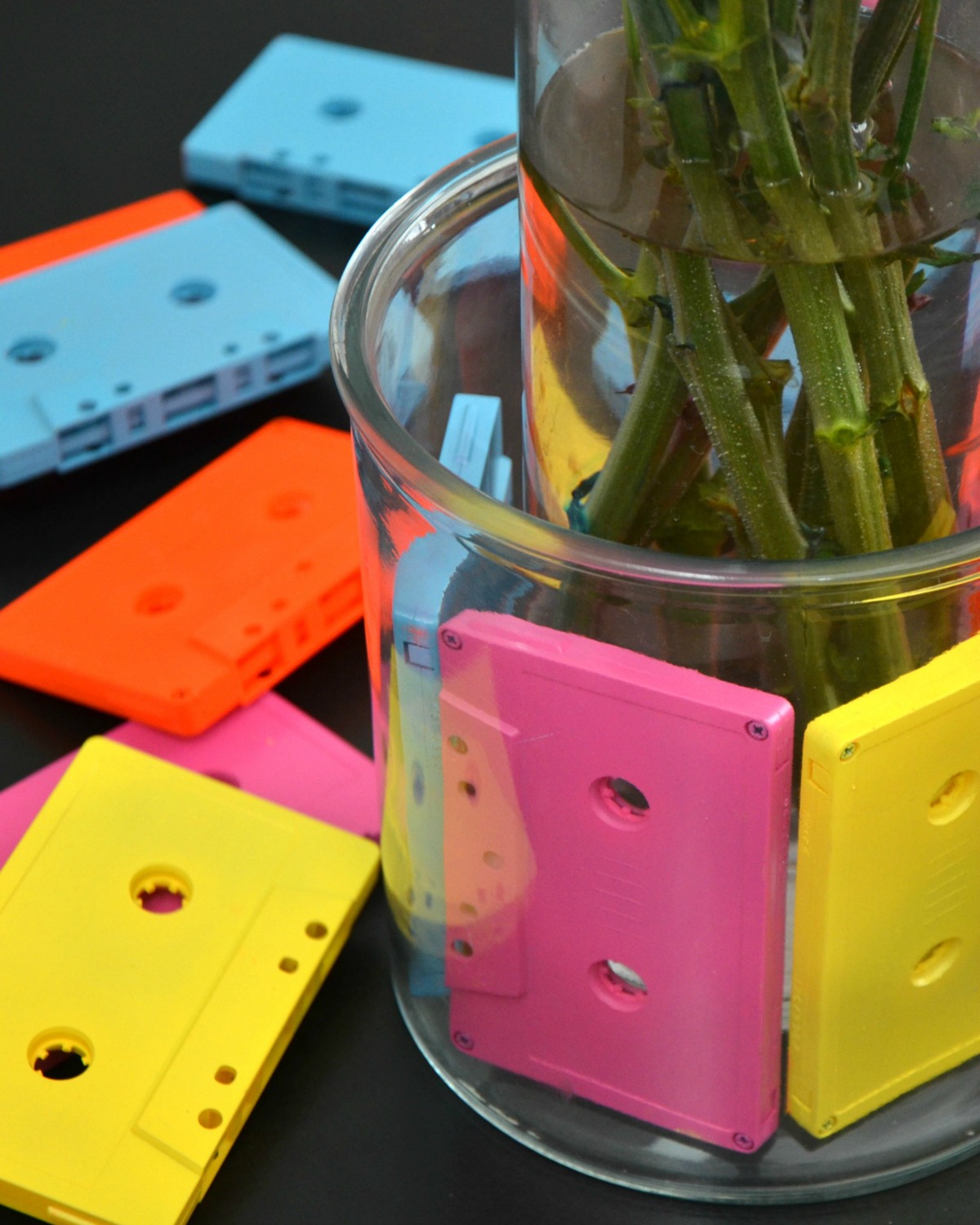 Use two vases and spray painted cassette tapes to make this fun cassette tape vase.