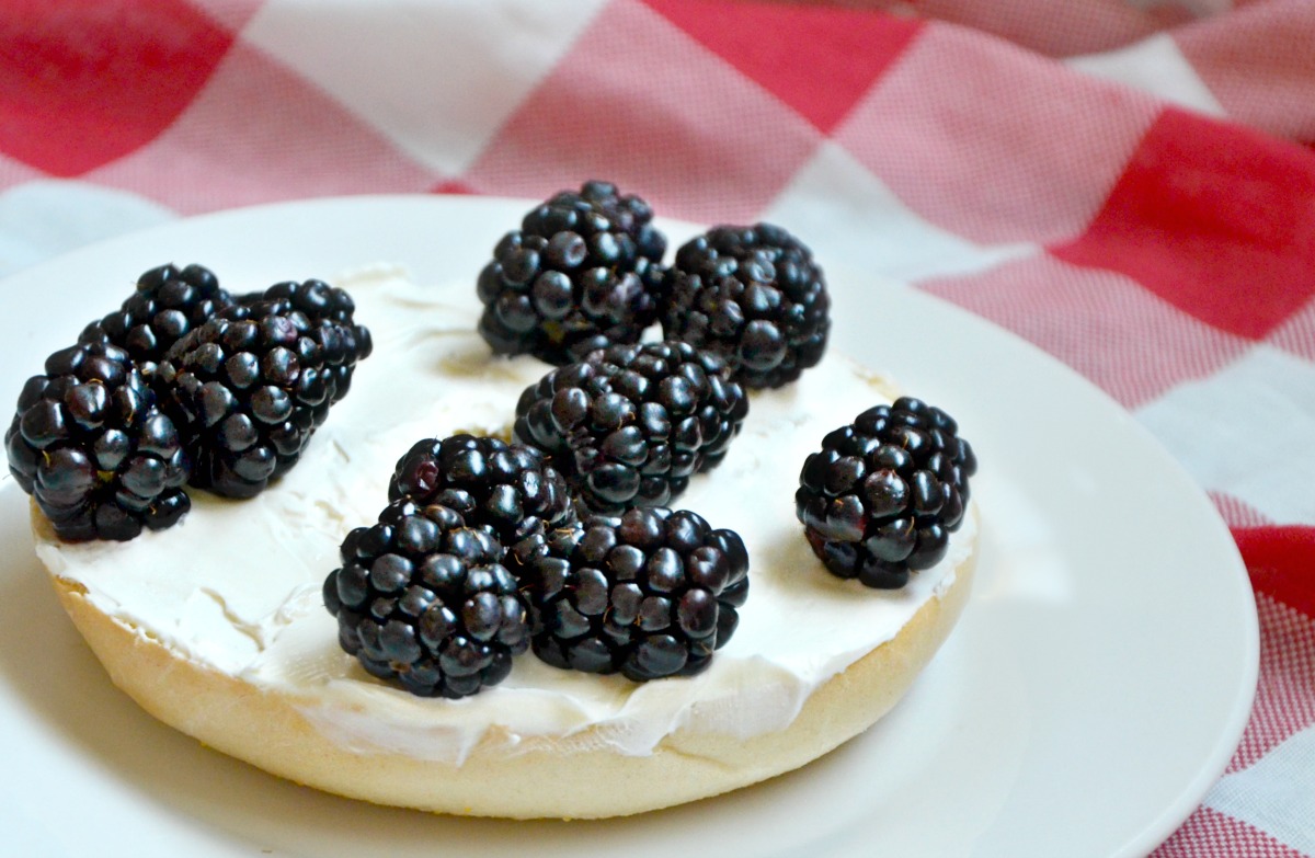 Cream cheese and blackberries on a bagel make a great "cow bagel" easy kids snack idea.