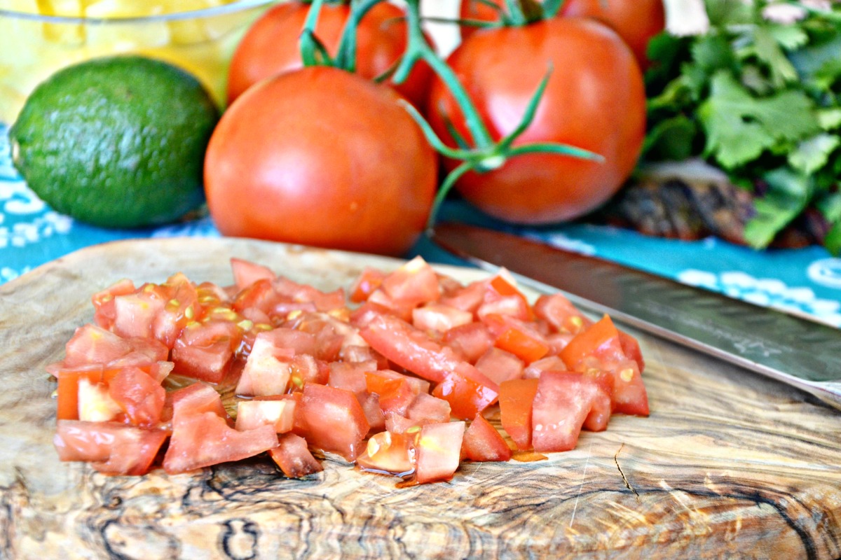 Dice fresh tomatoes for this easy pineapple salsa recipe.
