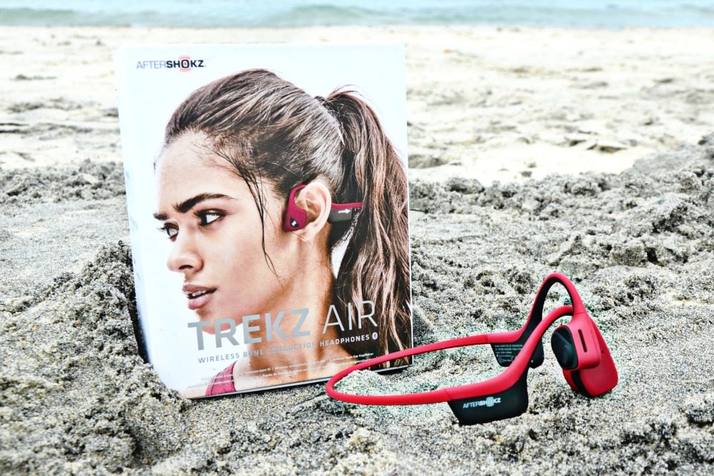 Get outside and play with these family beach day essentials including Trekz Air headphones.