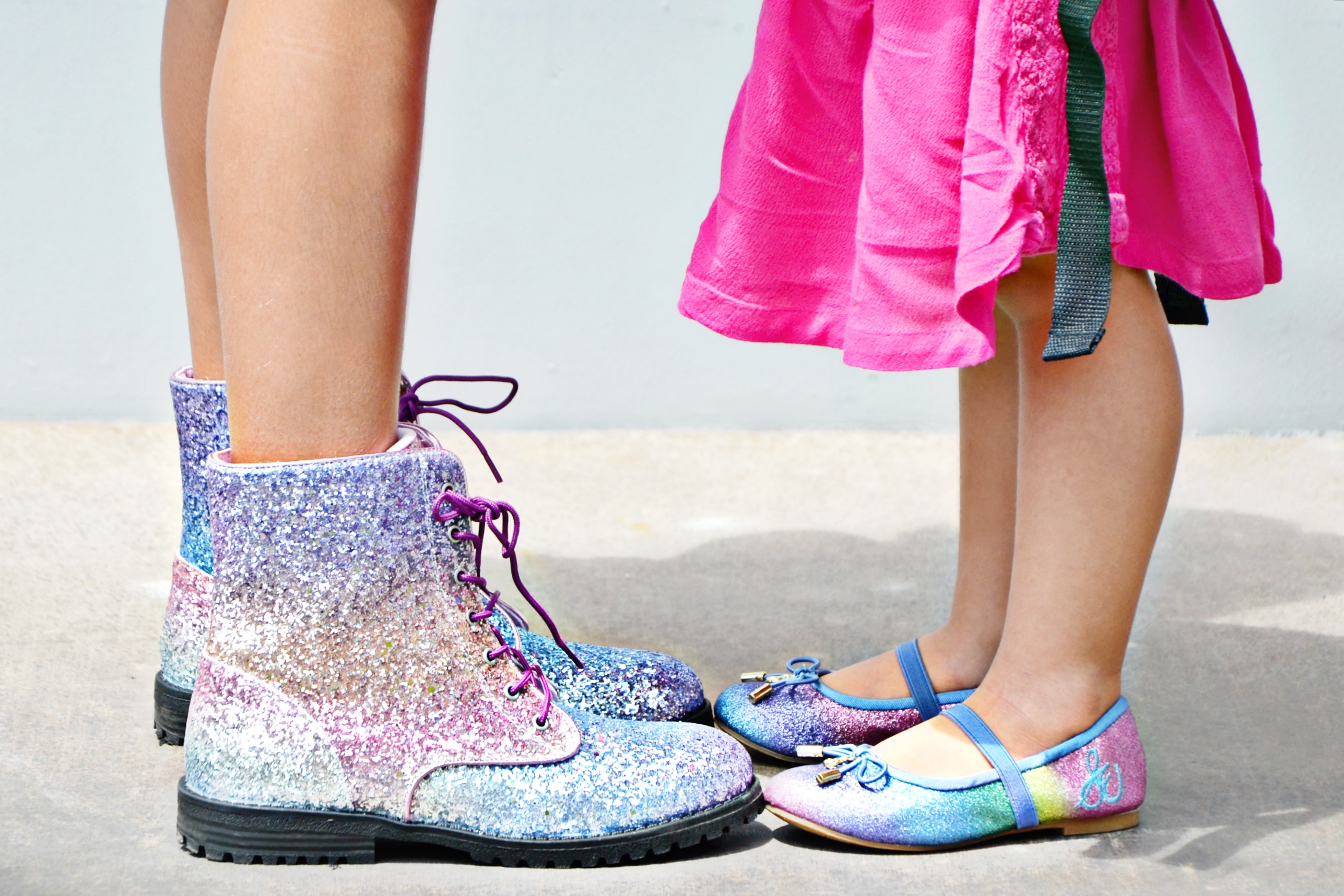 These sisters love their matching rainbow glitter shoes from KidsShoes.