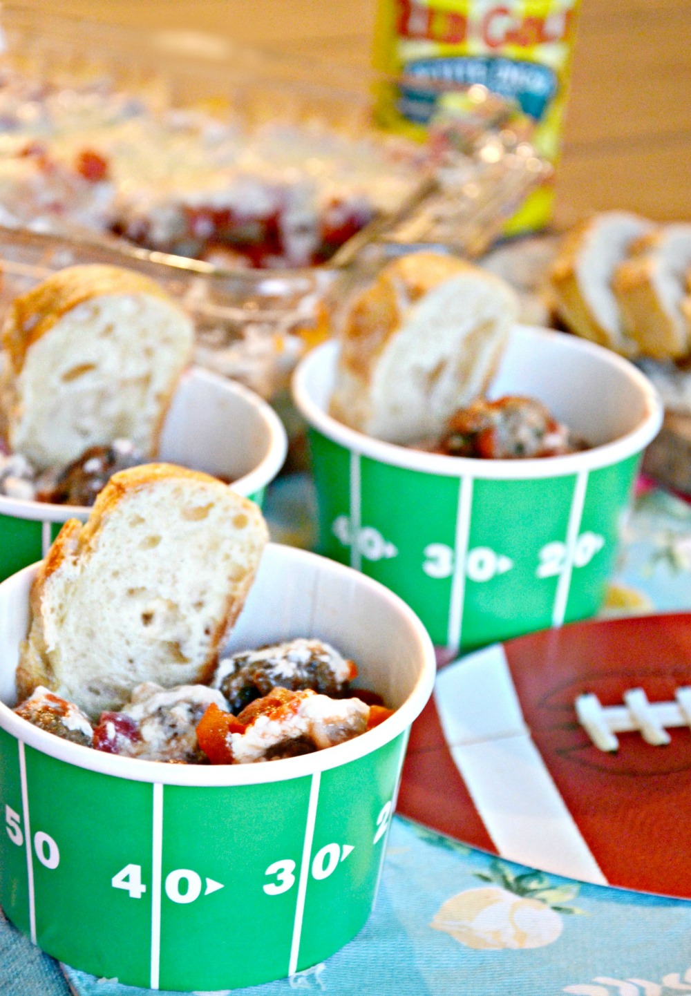 These Italian meatball dip cups with sliced bread are great for game day with family and friends.