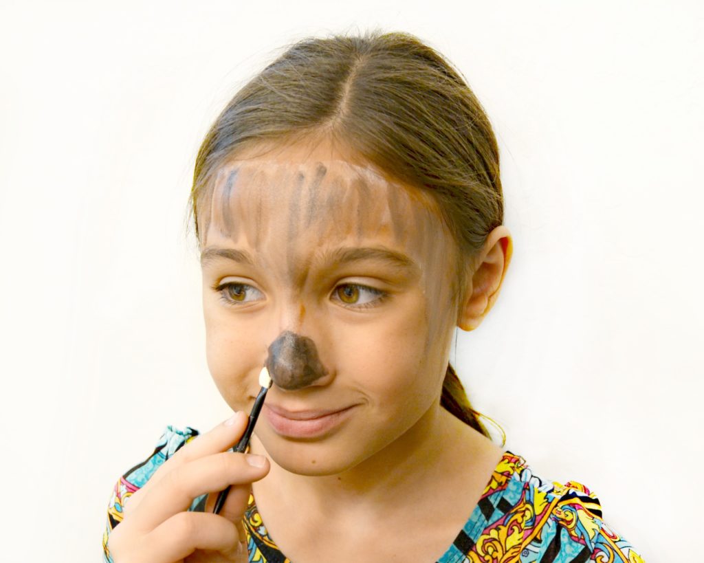 Use face paint to add makeup for your easy DIY porcupine costume.