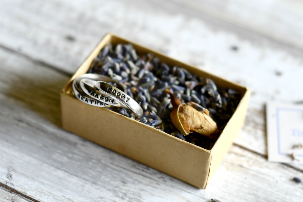 This personalized mother's ring arrives in lavender and rose bud packaging.