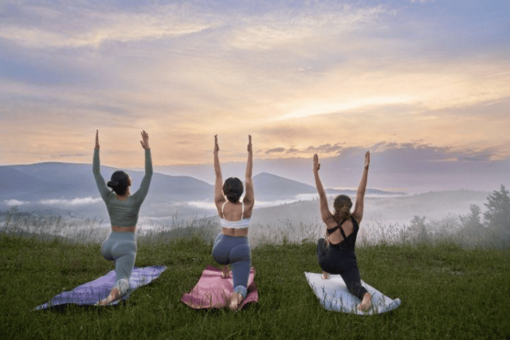 Women Doing Pose of Warrior in Mountains