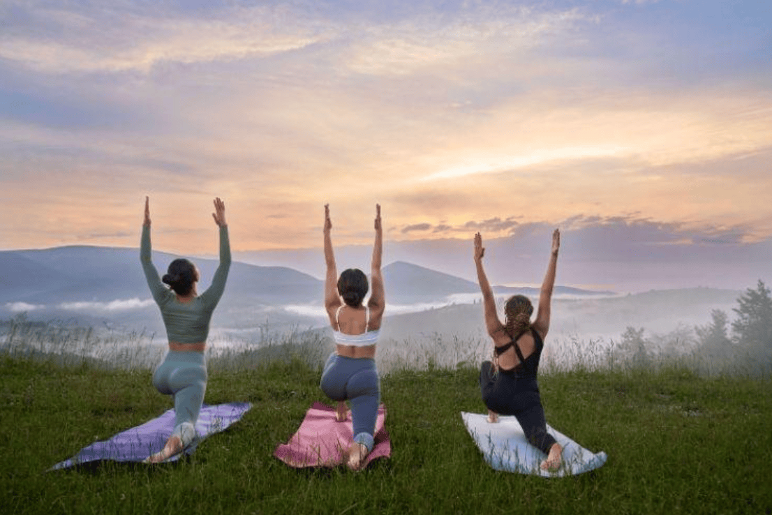 Women Doing Pose of Warrior in Mountains